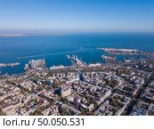 Beautiful panoramic view of the sea with the maritime station and part of the city of Odessa on a summer day. Aerial view from the drone. Aerial view of the drone on the city of Odessa and the sea with a maritime station against a blue sky on a sunny day. Стоковое фото, агентство Ingram Publishing / Фотобанк Лори