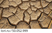 Detailed view of cracked, dry earth, showcasing the textured patterns of drought-affected soil. Concept of ecological disaster, negative human impact on environment. Стоковое AI-видео, аниматор Sergey Grishin / Фотобанк Лори