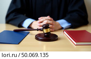 Closeup view of a judges desk featuring gavel books and judicial elements in a courtroom setting. Стоковое AI-изображение, AI-художник Андрей Бакусов / Фотобанк Лори