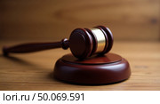 Polished wooden gavel with sound block on wooden surface reflecting justice and authority in legal proceedings. Стоковое AI-изображение, AI-художник Андрей Бакусов / Фотобанк Лори