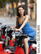 Young woman on rented bike on city street. Стоковое фото, фотограф Яков Филимонов / Фотобанк Лори