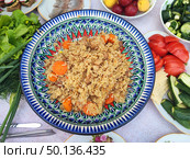 Плов на столе. Pilaf cooked in a cauldron. Стоковое фото, фотограф Денис Баданин / Фотобанк Лори
