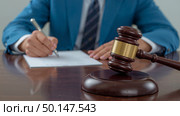 Closeup of wooden gavel on polished table. Стоковое AI-изображение, AI-художник Андрей Бакусов / Фотобанк Лори