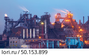 Metallurgical plant at night. Steel factory with smokestacks . Steelworks, iron works. Heavy industry in Europe. Air pollution from smokestacks, ecology problems. Industrial landscape at twilight. Стоковое фото, агентство Ingram Publishing / Фотобанк Лори