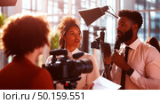 Professional engagement between two presenters in a modern studio during a promotional event in the afternoon light. Стоковое AI-изображение, AI-художник Сергей Толмачёв / Фотобанк Лори