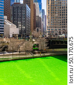 Chicago Skylines building along green dyeing river of Chicago River on St. Patrick day festival in Chicago Downtown IL USA. Стоковое фото, агентство Ingram Publishing / Фотобанк Лори