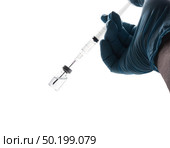 Hand in a blue glove holding syringe isolated on white background. Стоковое фото, агентство Ingram Publishing / Фотобанк Лори
