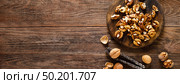 Walnuts. Kernels and whole nuts on wooden rustic table, banner, top view. Стоковое фото, агентство Ingram Publishing / Фотобанк Лори