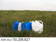 Chemical weeding of the field. Use of herbicides in agriculture. Containers with chemical preparation at the edge of the field after harvesting green fodder. Стоковое фото, фотограф Роман Дзюбало / Фотобанк Лори