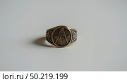 Masonic ring on white background. Стоковое AI-изображение, AI-художник Андрей Бакусов / Фотобанк Лори