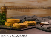 Raw veggie burger with chickpeas, vegetables and parsley leaves on kitchen countertop. Стоковое фото, агентство Ingram Publishing / Фотобанк Лори