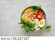 Buddha bowl with grilled chicken breast, tomato, onion, corn, avocado, fresh basil salad and rice, healthy balanced eating for lunch. Стоковое фото, агентство Ingram Publishing / Фотобанк Лори