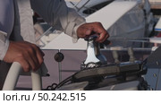 Close-up of the captain's hands at the helm. He controls the movement of the yacht. Стоковое видео, видеограф Aleksey Kidisyuk / Фотобанк Лори