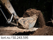 Excavator working with soil and water, during earthmoving works. Стоковое фото, агентство Ingram Publishing / Фотобанк Лори