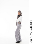 Full body portrait of Confident happy smiling female muslim woman with EDC machine as owner merchant concept. Studio shot on white background. Using for sale consumerism and shopaholic concept. Стоковое фото, агентство Ingram Publishing / Фотобанк Лори