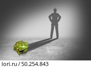 Frog prince casting a shadow of a royal prince charming wearing a gold crown representing the fairy tale concept of change and transformation from an amphibian to a young future king in a 3D illustration style. Стоковое фото, агентство Ingram Publishing / Фотобанк Лори