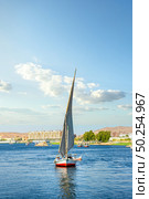 Sailboat riding on Nile river at summer day in Aswan. Стоковое фото, агентство Ingram Publishing / Фотобанк Лори