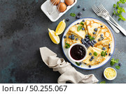 Crepes, thin pancakes with blueberry jam and fresh berries with lemon zest. Стоковое фото, агентство Ingram Publishing / Фотобанк Лори