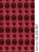 Geometric pattern from glasses with red wine alcoholic drink on a red background with hard shadows. Top view.. Red wine glasses pattern with hard dark shadows. Стоковое фото, агентство Ingram Publishing / Фотобанк Лори
