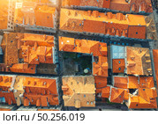 Aerial view of houses with orange roofs at sunset in summer in Dubrovnik, Croatia. Top view of beautiful architecture in european old city. Historical centre, buildings, street in the evening. Travel. Стоковое фото, агентство Ingram Publishing / Фотобанк Лори