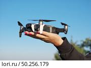 Drone landing on a woman hand palm. Element of design. Стоковое фото, агентство Ingram Publishing / Фотобанк Лори