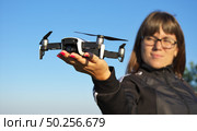 Drone landing on a woman hand palm. Element of design. Стоковое фото, агентство Ingram Publishing / Фотобанк Лори