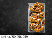 Homemade chocolate puff pastry braided strudel, pie with pecan nuts and almond, top view. Стоковое фото, агентство Ingram Publishing / Фотобанк Лори