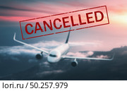 Canceled flights in Europe and USA airports. Travel vacations cancelled because of pandemic of coronavirus. Flying passenger airplane. Flight cancellation. Blurred aircraft with text. Covid-19. Стоковое фото, агентство Ingram Publishing / Фотобанк Лори