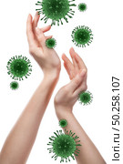 Female’s hands with flying models of Coronavirus molecules on a white background, copy space. Concept of regular handwashing as a preventive method during pandemic of Coronavirus, Covid-19.. Womans hands and Coronavirus bacteria. Стоковое фото, агентство Ingram Publishing / Фотобанк Лори