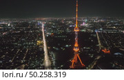 A drone over the city at night flies around a TV tower illuminated by lights. Cloudless Summer Night. Стоковое видео, видеограф Aleksey Kidisyuk / Фотобанк Лори
