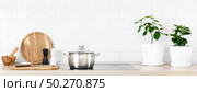White modern kitchen interior with wooden worktop and kitchenware, culinary concept, background, banner. Стоковое фото, агентство Ingram Publishing / Фотобанк Лори
