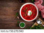 Traditional ukrainian borscht, vegetable soup with tomato, beet, carrot, potato, pepper, cabbage and fresh greens, beetroot soup. Healthy vegetarian food. Стоковое фото, агентство Ingram Publishing / Фотобанк Лори
