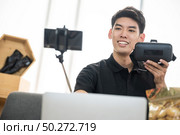 Young male vlogger live vlog video for selling online. online marketing concept. Стоковое фото, агентство Ingram Publishing / Фотобанк Лори