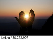 Faith of christian concept: Spiritual prayer hands over sun shine with blurred beautiful sunset background. Стоковое фото, агентство Ingram Publishing / Фотобанк Лори