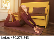 Finding Flexibility Friday With a Beautiful Backbend in Her Living Room. Стоковое фото, фотограф Aleksandr Golubev / Фотобанк Лори