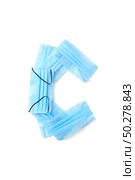 Capital letter C handmade from medical antibacterial protective blue face masks on a white background, copy space. Creative alphabet for making up new words.. Letter C made from protective medical masks on a white background. Стоковое фото, агентство Ingram Publishing / Фотобанк Лори