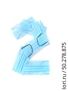Figure 2, two handmade from medical antibacterial protective blue face masks on a white background, copy space. Creative typeface for making up new numerical information.. Number two made from protective medical masks on a white background. Стоковое фото, агентство Ingram Publishing / Фотобанк Лори