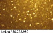 An abstract gold background with sparkle lights and bokeh. Useful as Christmas background or greeting card. Gold blurred light. Стоковое видео, видеограф Марина Демидюк / Фотобанк Лори