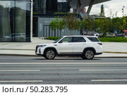 Fast moving Changan CS95 Plus on the city road. White SUV with man driving. Chinese auto in fast motion with blurred background. Speeding in the city concept. Редакционное фото, фотограф Константин Григорьев / Фотобанк Лори
