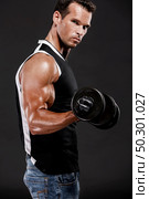 Muscle man in studio lifting weights, isolated over a white background. Стоковое фото, агентство Ingram Publishing / Фотобанк Лори