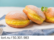 Bolas de Berlim, or "Berlin Balls". Portuguese fried dough with sugar, Filled with sweet egg cream. Стоковое фото, агентство Ingram Publishing / Фотобанк Лори