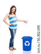Beautiful young woman doing recycling, isolated over white background. Стоковое фото, агентство Ingram Publishing / Фотобанк Лори