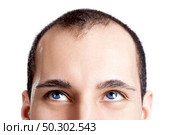 Close-up portrait of a young man with blue eyes isolated on white - OBS: model use lens contact. Стоковое фото, агентство Ingram Publishing / Фотобанк Лори