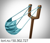Health as a weapon and weaponized medicine as a face mask or mevical covering shaped as a slingshot as a 3D render. Стоковое фото, агентство Ingram Publishing / Фотобанк Лори