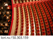 Beautiful of the empty parterre and part of the orchestra pit in the theatre concert hall of Vienna State Opera auditorium with red seats in the rows without people in Vienna, Austria.. The parterre in the theatre hall of Vienna State Opera auditorium without people. Стоковое фото, агентство Ingram Publishing / Фотобанк Лори