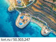 Aerial view of beautiful sandy beach, blue sea, restaurants on the promenade, pool, umbrellas, swimming people in clear water, green trees at sunset in summer. Top view of seafront. Tropical landscape. Стоковое фото, агентство Ingram Publishing / Фотобанк Лори