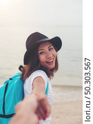 Woman wanting her man to follow her in vacation  to beach. Couple in love concept. Стоковое фото, агентство Ingram Publishing / Фотобанк Лори
