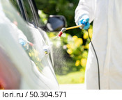 Close up chemical alcohol spray cleaning on door handle to disinfect and decontaminate coronavirus covid-19 by specialist cleaner wear personal protective equipment PPE. New normal Hygiene concept. Стоковое фото, агентство Ingram Publishing / Фотобанк Лори
