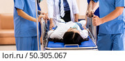 Panorama close up medical team of doctor and nurse push gurney stretcher with seriously injured patient with oxygen mask to the Operating Room. Emergency health care and medical hospital concept. Стоковое фото, агентство Ingram Publishing / Фотобанк Лори