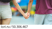 Young lovers couple hold hands, dating at amusement park, concept of happy, love, and relaxing. Стоковое фото, агентство Ingram Publishing / Фотобанк Лори
